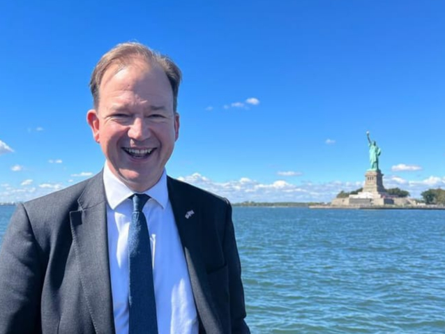 Jesse Norman MP, aboard the HMS Queen Elizabeth, in front of the Statue of Liberty.