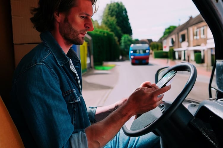 Man using phone at wheel