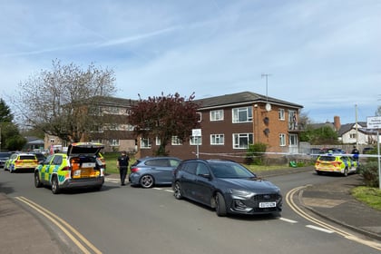 Man in hospital and woman arrested following car incident