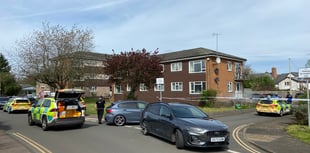 Man in hospital and woman arrested following car incident