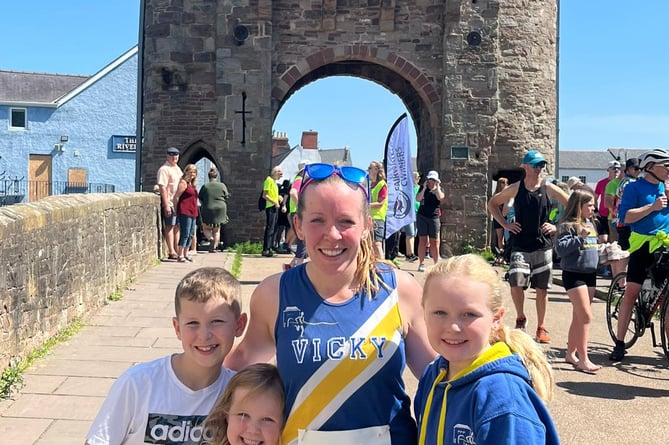 Vicky Roberts with her children after finishing her leg at Monnow Bridge