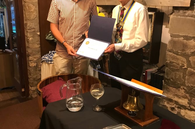 Guy Wilson, left, is presented with the Paul Harris Fellowship by Chepstow Rotary president David Burr.