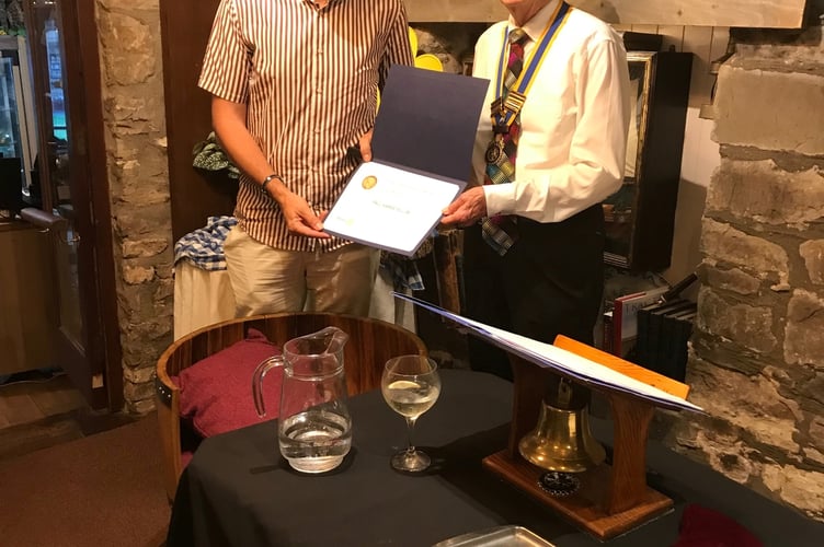 Guy Wilson, left, is presented with the Paul Harris Fellowship by Chepstow Rotary president David Burr.