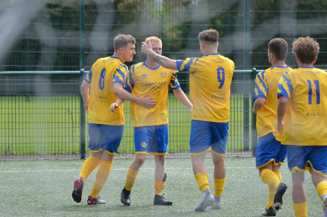 Monmouth Town players celebrate a goal