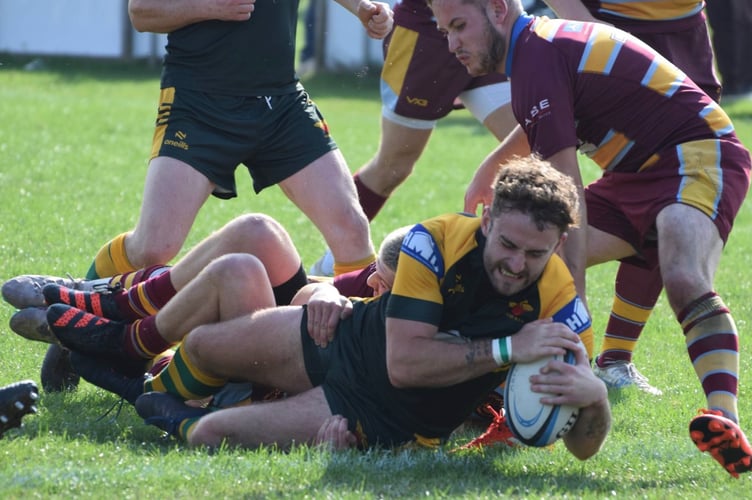 A Newent player grounds the ball