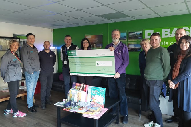 Sally Thomas-Brown, Mike Jones, Chris Turner presenting the cheque to Chris and Asiza, Jenny Hudson, Ben Browning, Adam Wilce and Miranda Palmer
