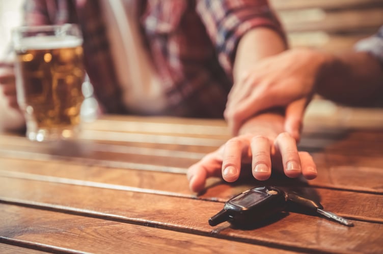 Do not drink and drive! Cropped image of drunk man talking car keys and his friend stopping him